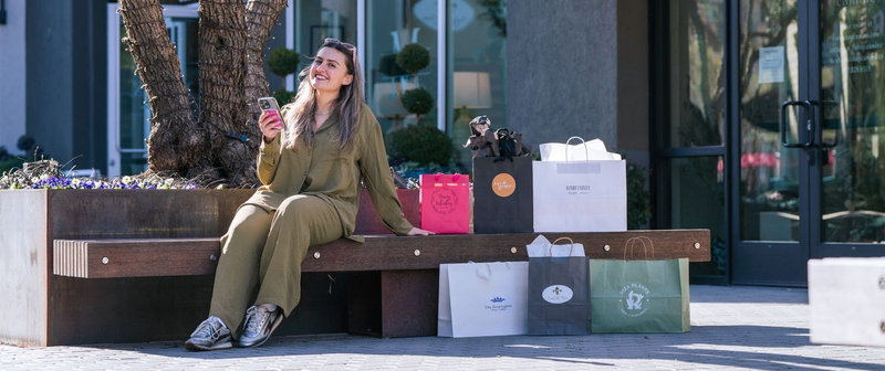 a woman shopping at First Street Napa’s sidewalk sale, as featured in the Azur Wines wine blog on the best spots to see in downtown Napa in a day