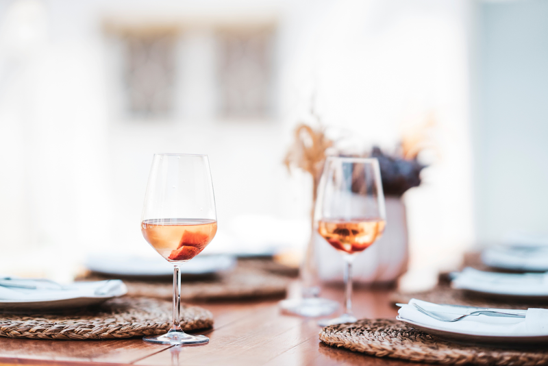 Azure wine glasses filled with a vibrant shot of rosé wine, a delightful blend of white and red wine. 