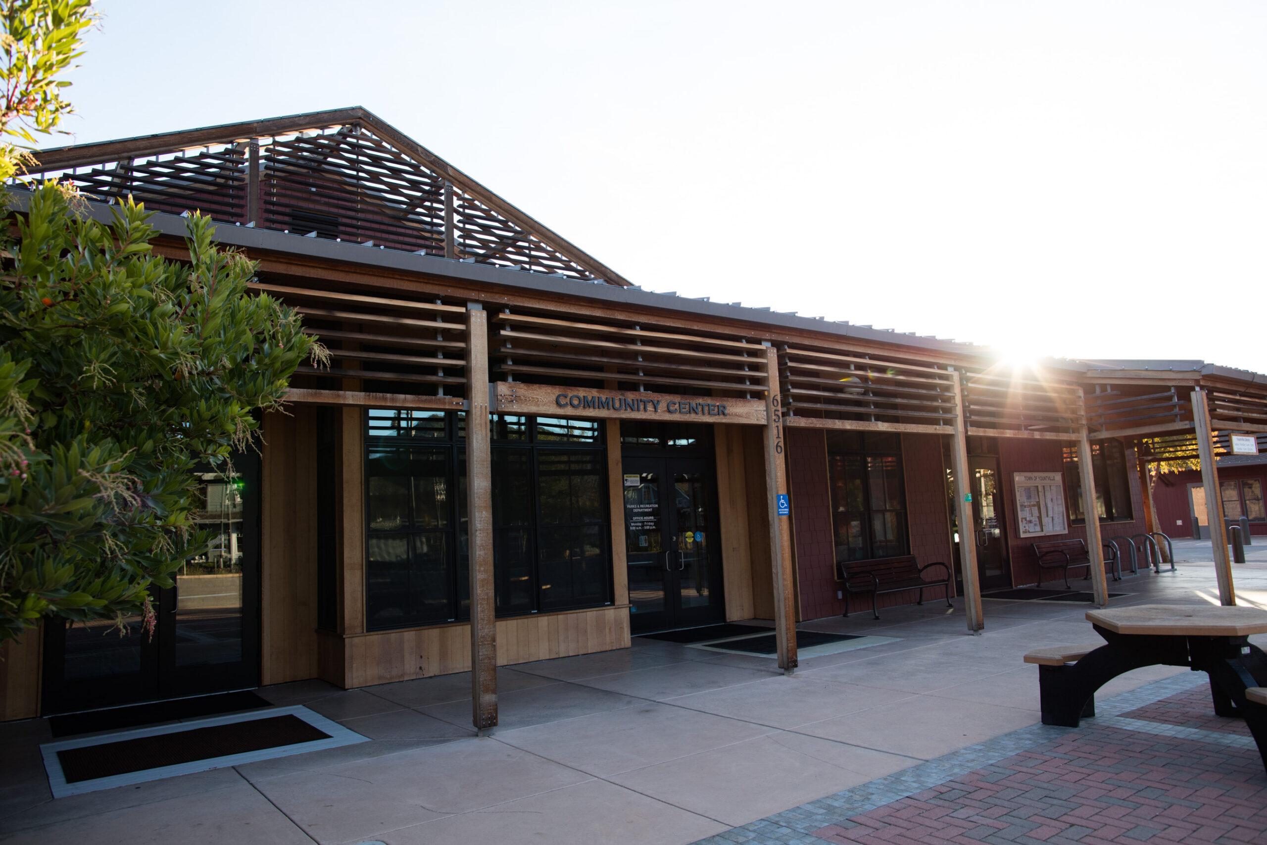 The Community Center entrance and paved courtyard, with its name visible above the doors.